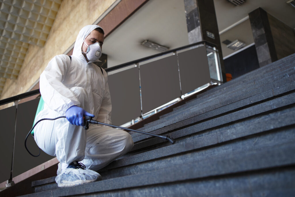 person white chemical protection suit disinfecting public corridors steps stop spreading highly contagious corona virus